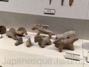 Figures of horses in terra-cotta tomb figurines.